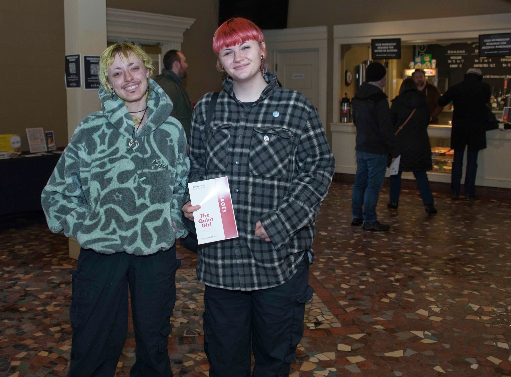 Attendees holding brochure